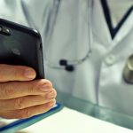 doctor looking at their iPhone