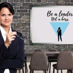 a business woman standing next to a white board with the words be a leader not a boss written on it: the top leadership qualities